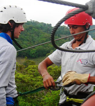 Putting on your harness for canopy tours